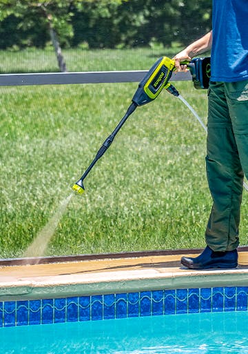 Sun Joe 24-volt Cordless Power Cleaner Kit being used to wash and clean the area around a pool.